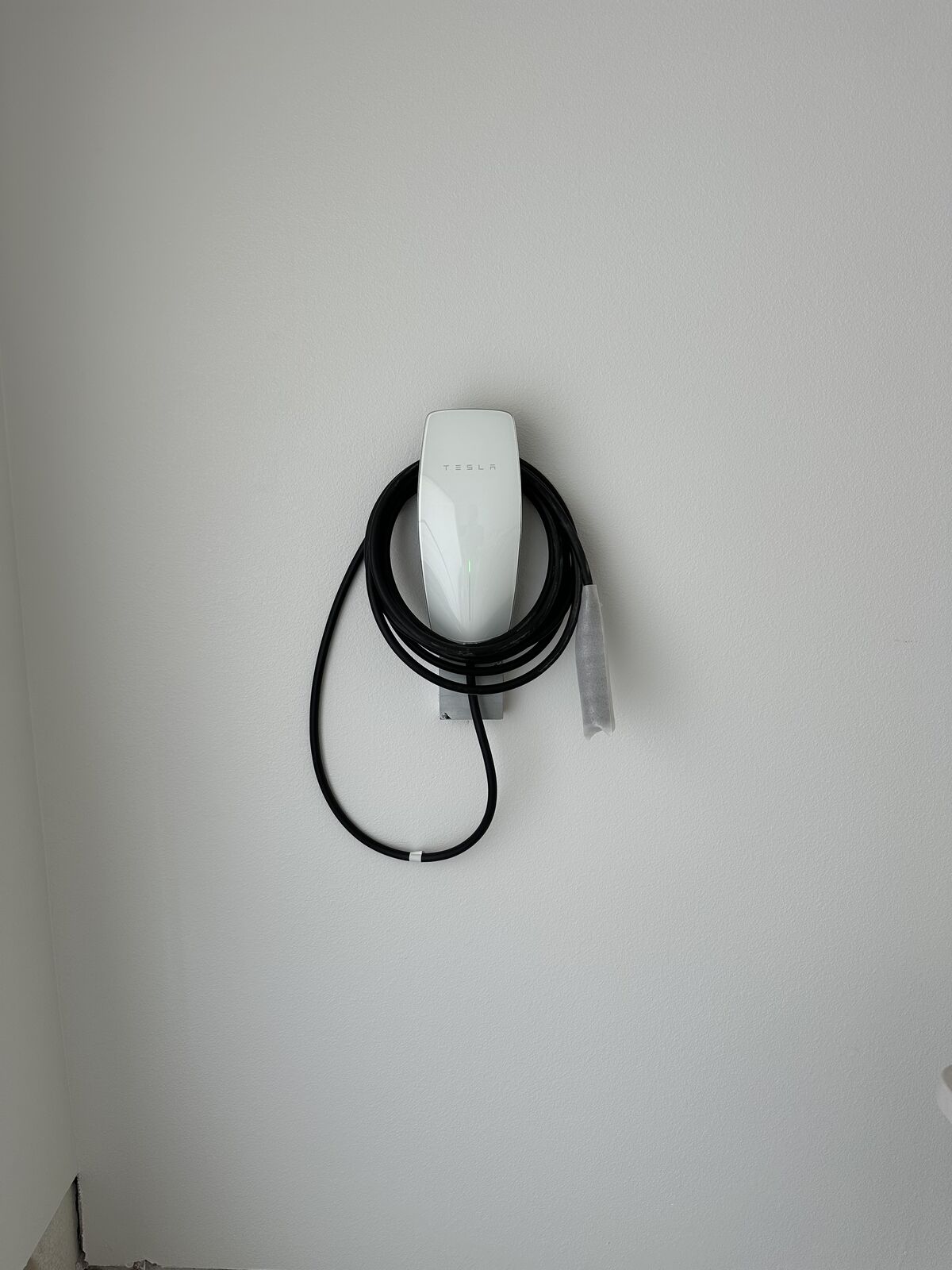 Level 2 EV charger installed on a home exterior wall