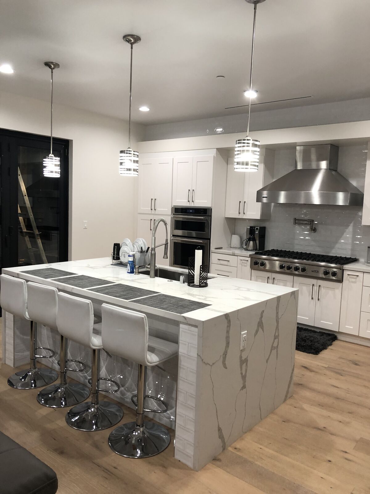 Kitchen island with a row of pendant lights in a new home